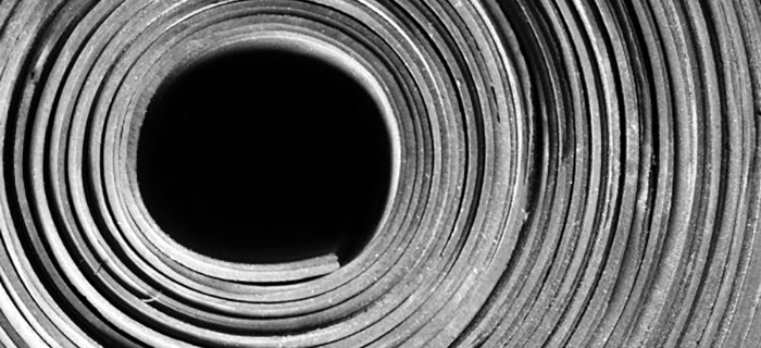 Close up of a roll of black conveyor belting with no core - GCP Industrial Products