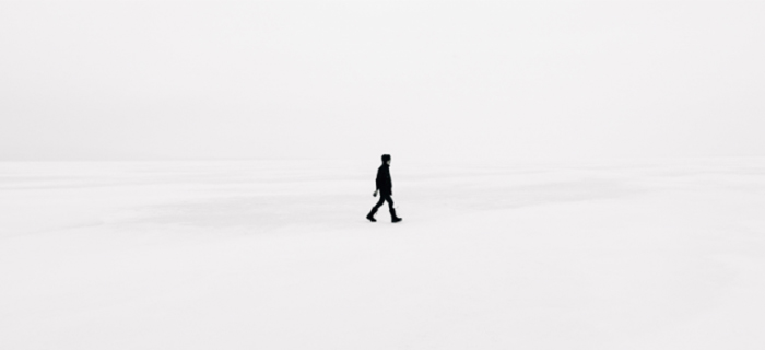 Icon of a person in black walking alone on a all white backdrop - GCP Industrial Products